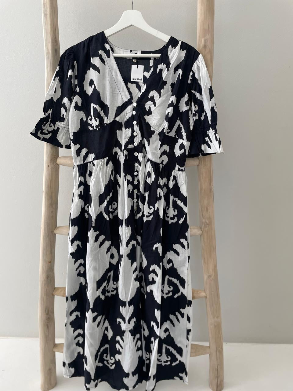 Black dress with bold white floral pattern