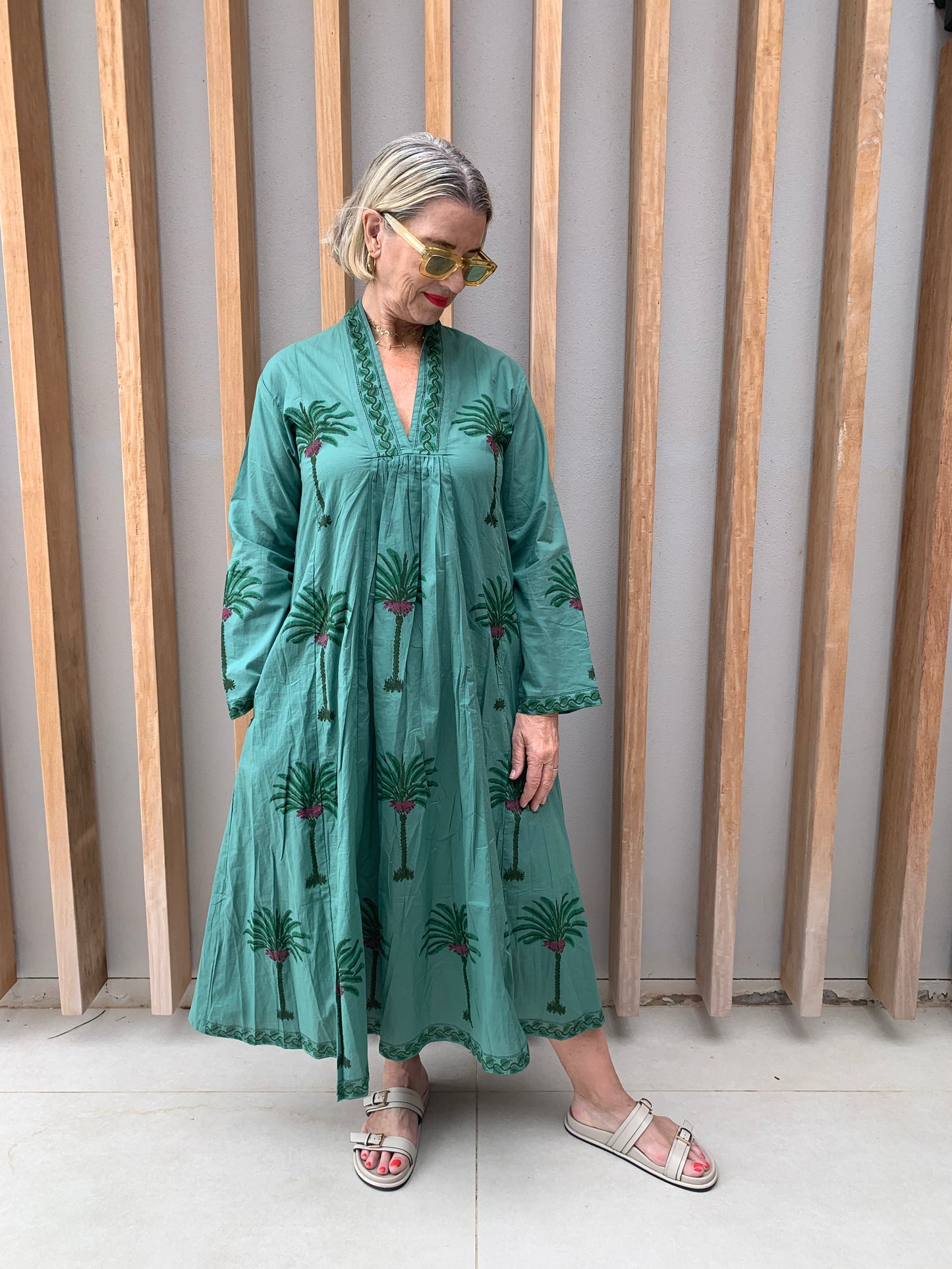 Green dress with floral palm pattern
