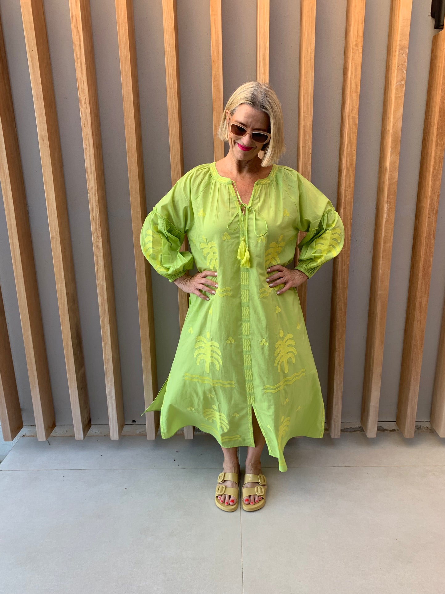 Lime green dress with embroidered palm pattern