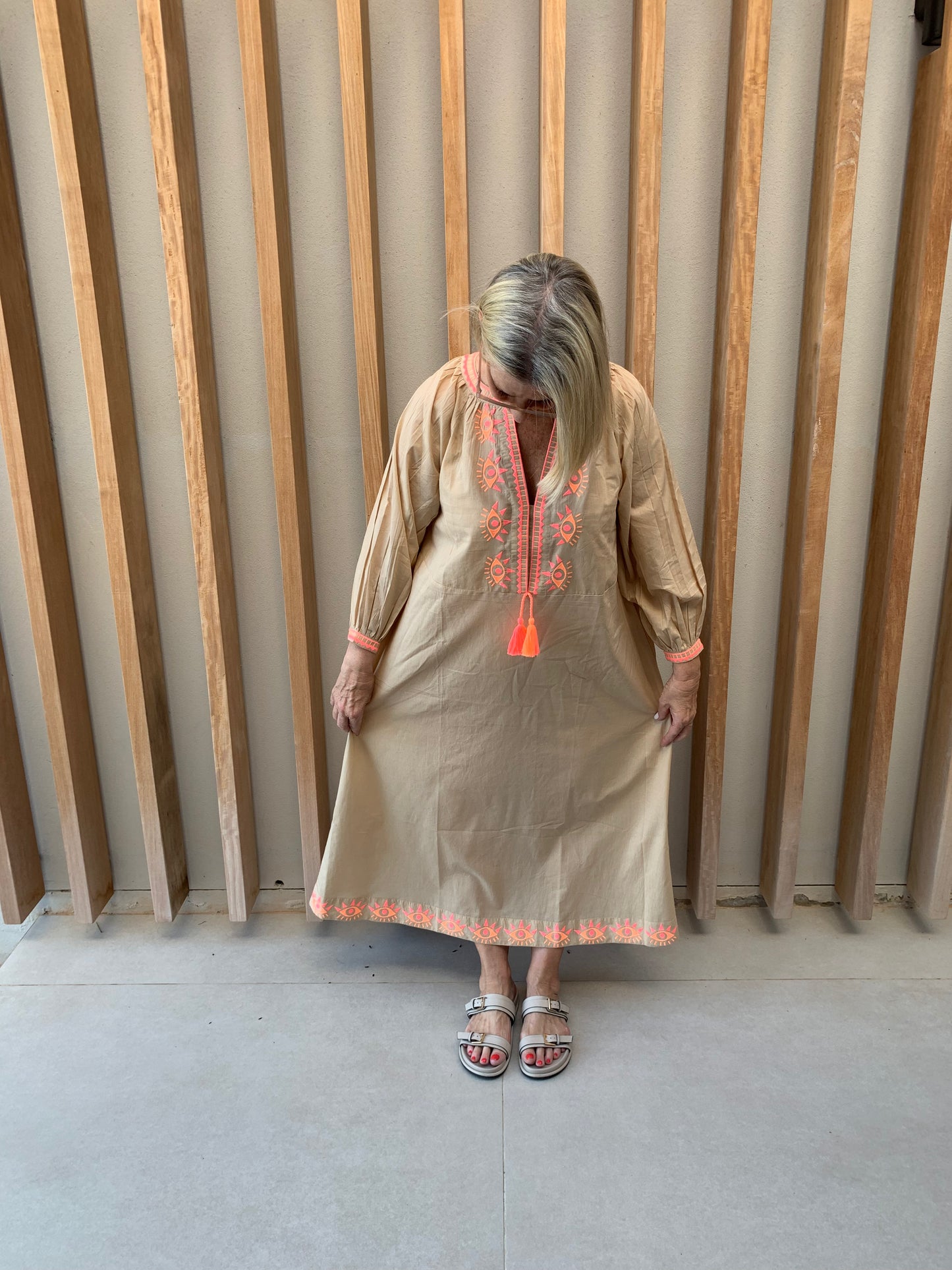 Nude colour dress with orange geometric pattern