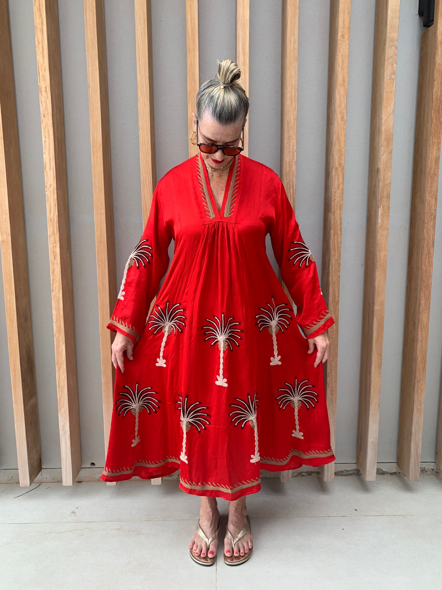 Red silk dress with floral palm pattern