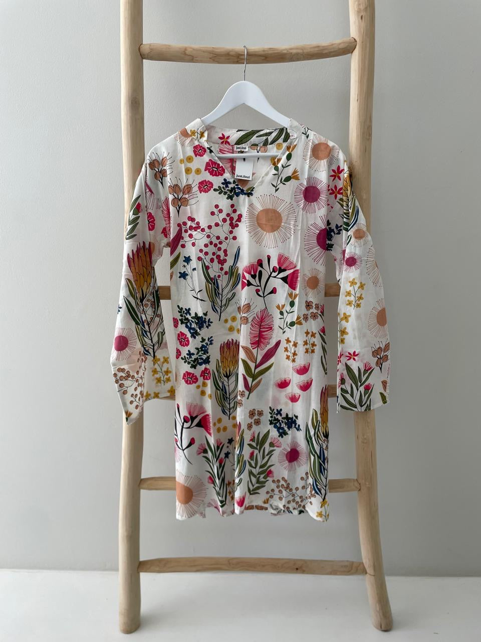 White dress with floral protea