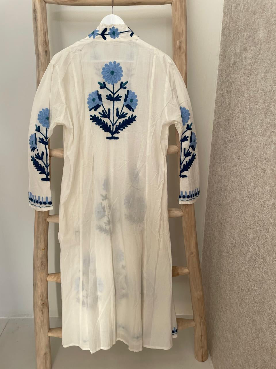 White dress with embroidered light blue daisies