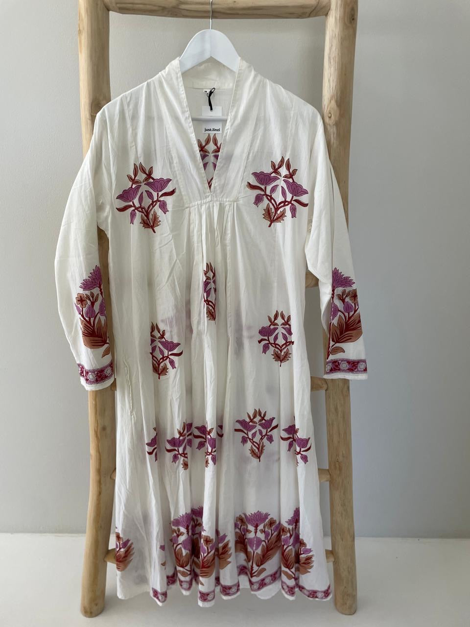 White dress with red floral pattern