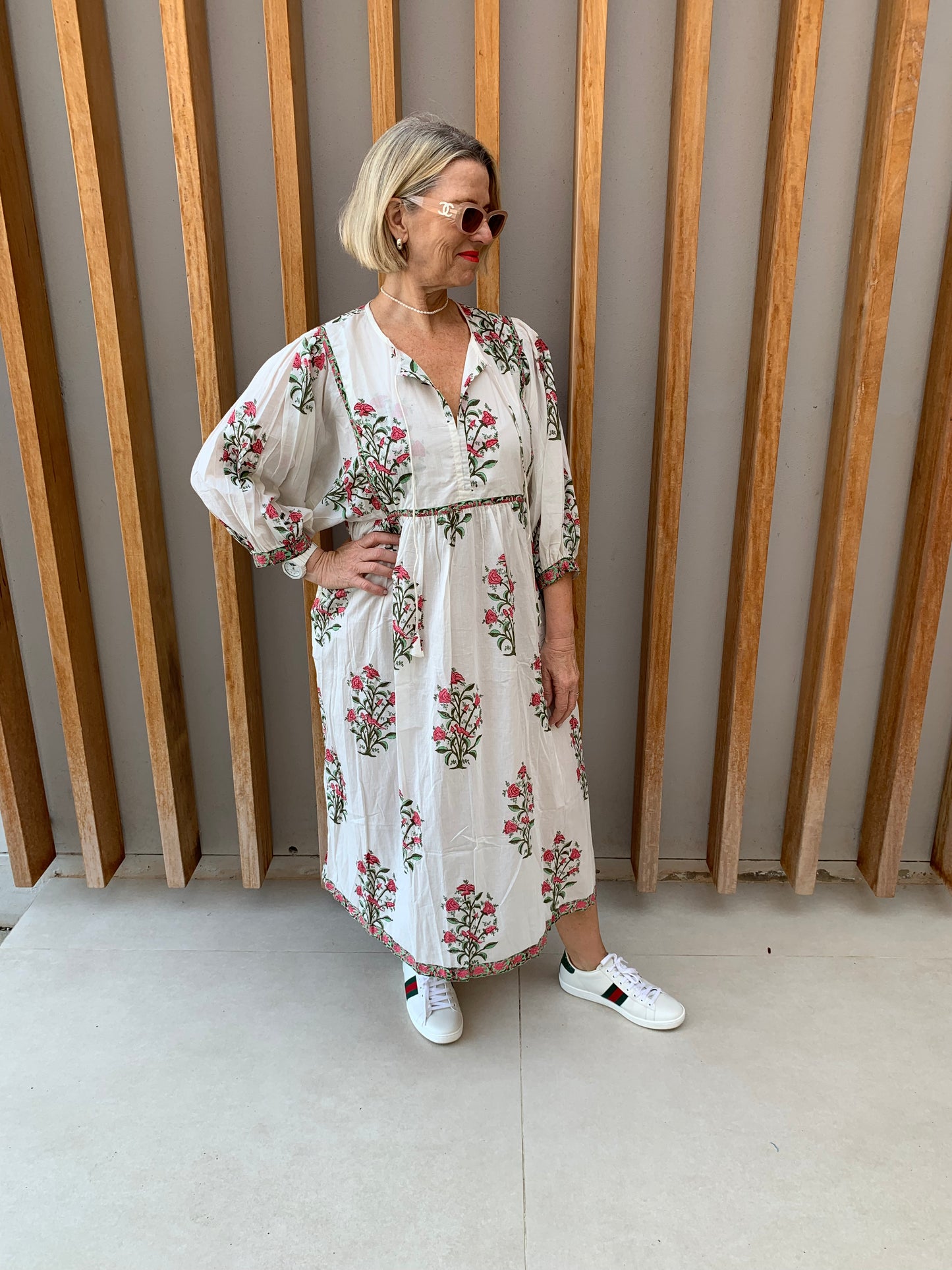 White dress with red rosebush floral pattern