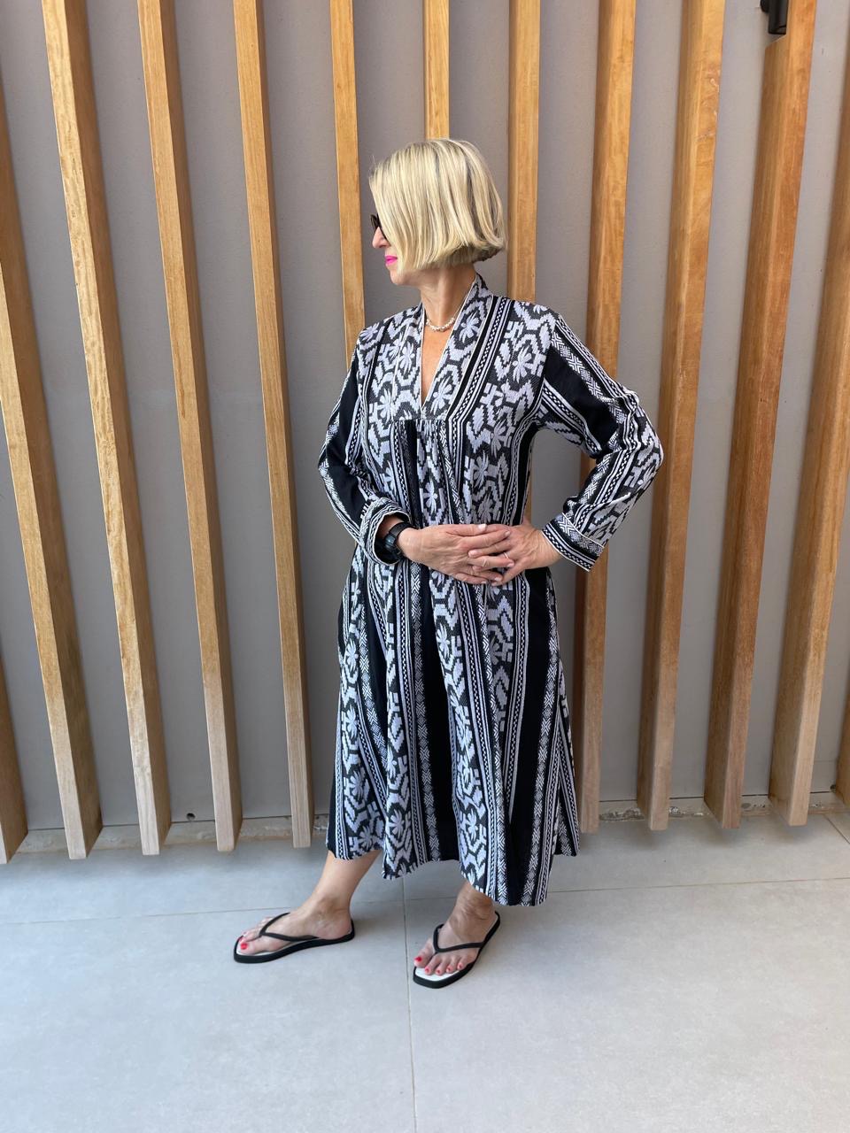 Black dress with white embroidered geometric pattern