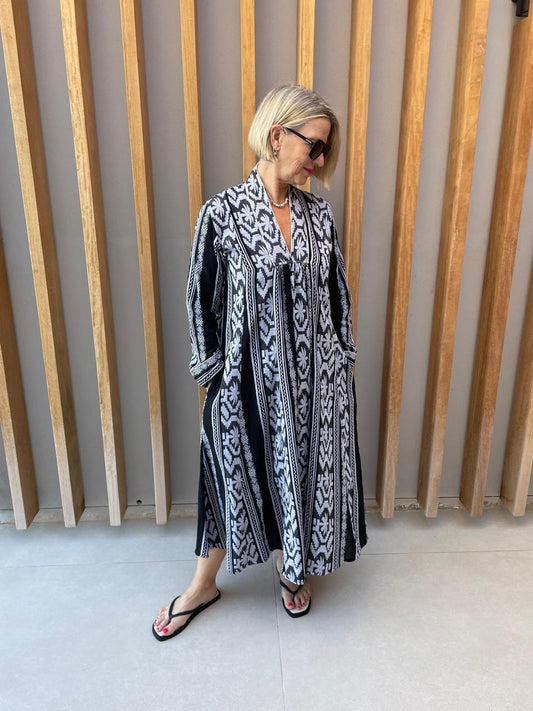Black dress with white embroidered geometric pattern