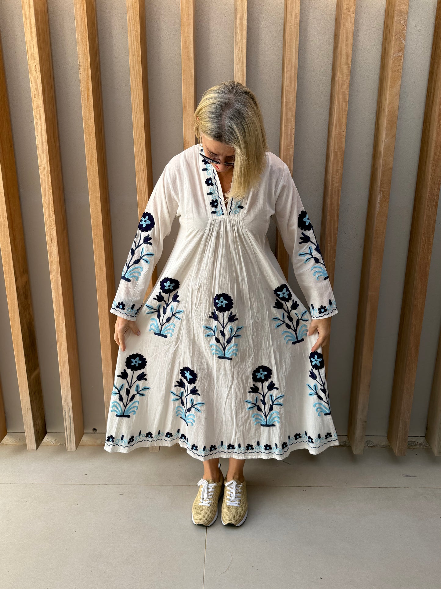 White dress with embroidered blue daisies