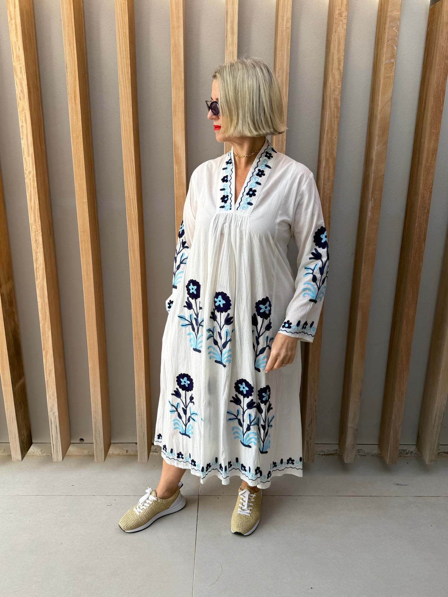 White dress with embroidered blue daisies