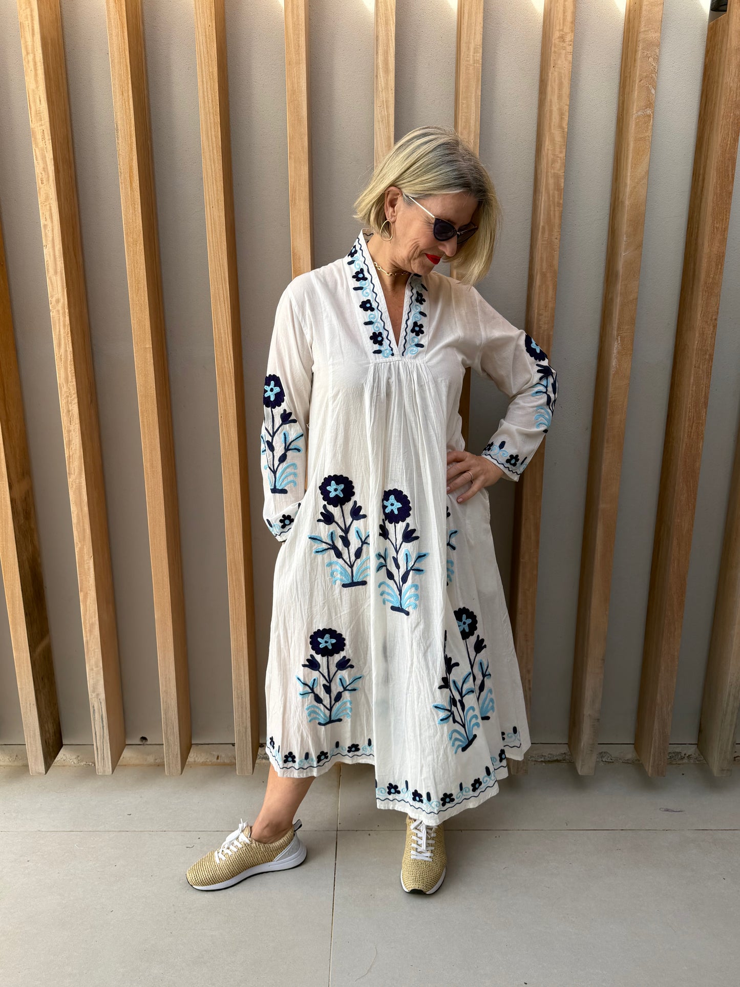 White dress with embroidered blue daisies
