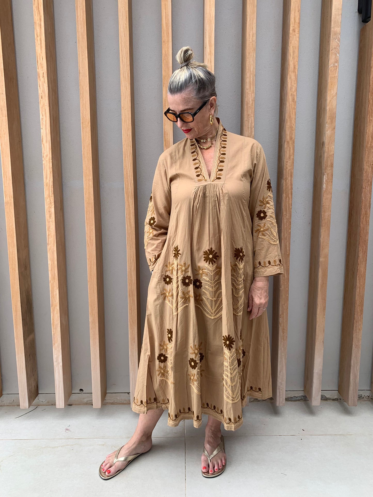 Caramel coloured dress with embroidered brown daisies