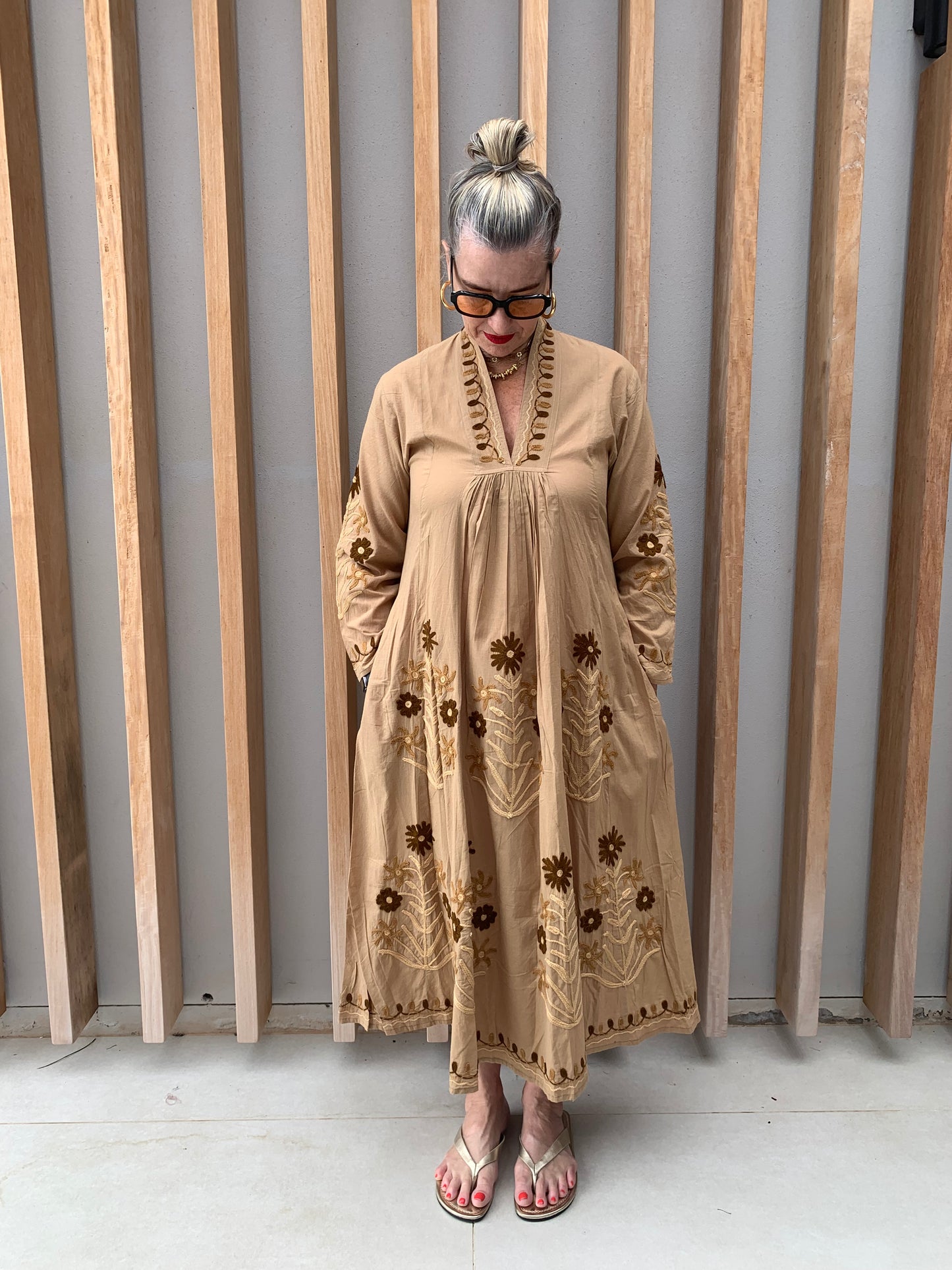 Caramel coloured dress with embroidered brown daisies
