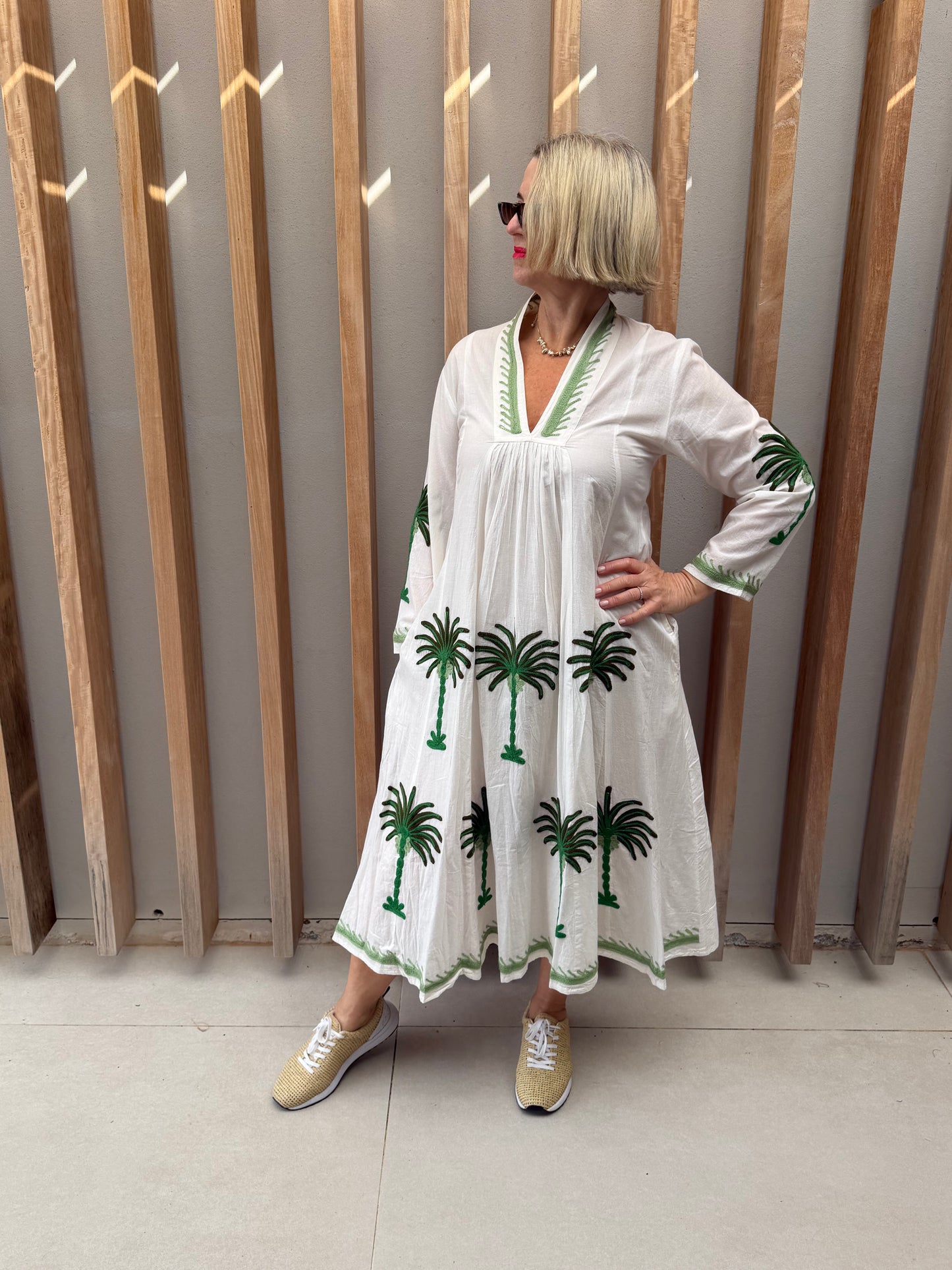 White dress with embroidered green palm