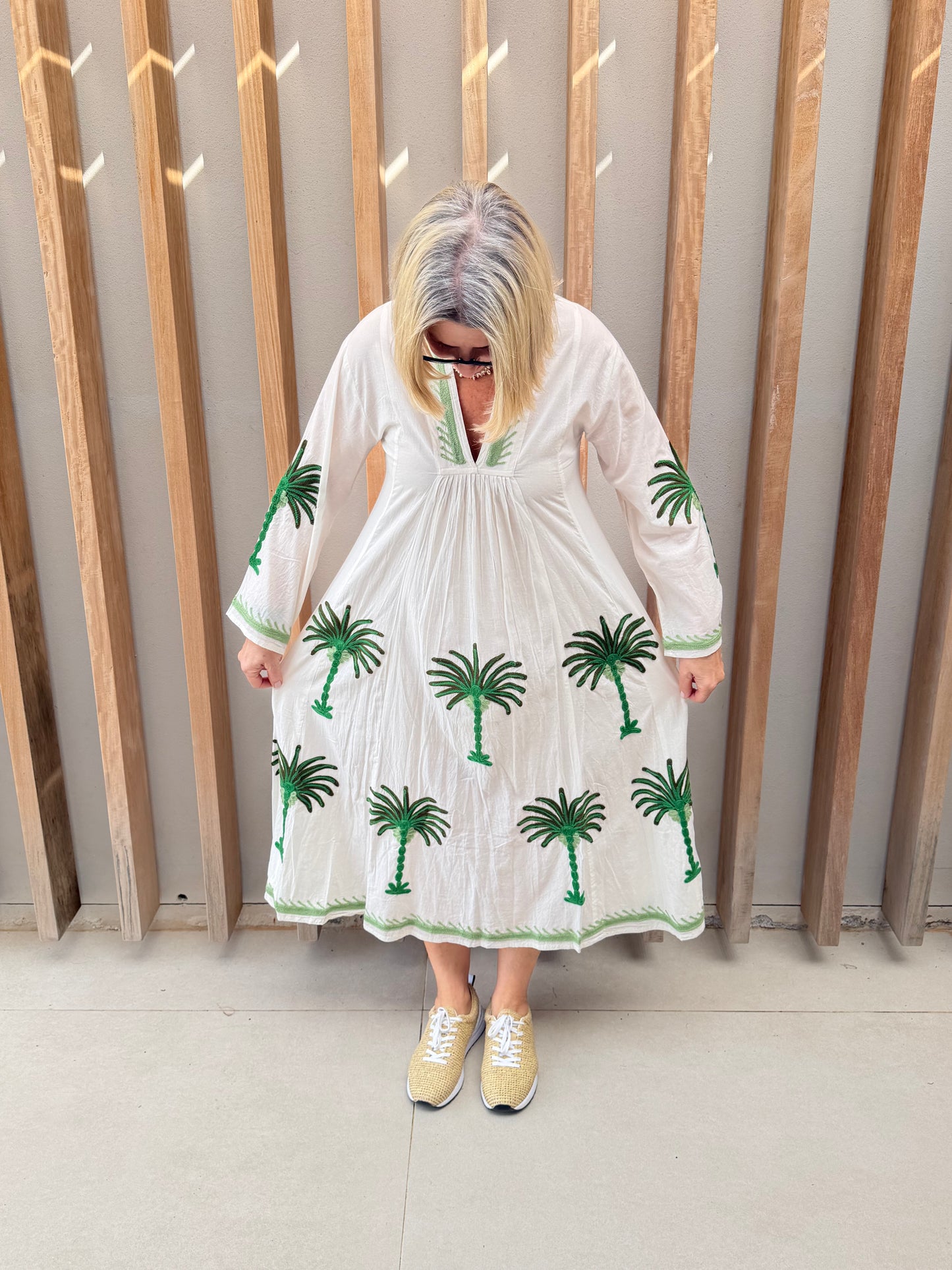 White dress with embroidered green palm