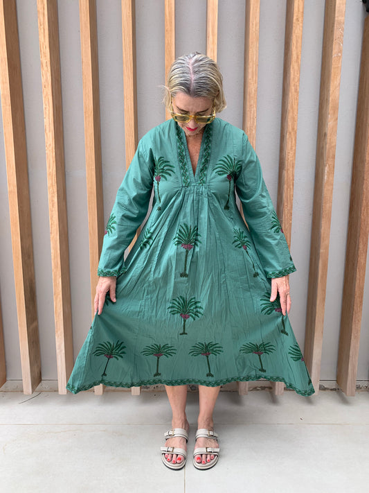 Green dress with floral palm pattern