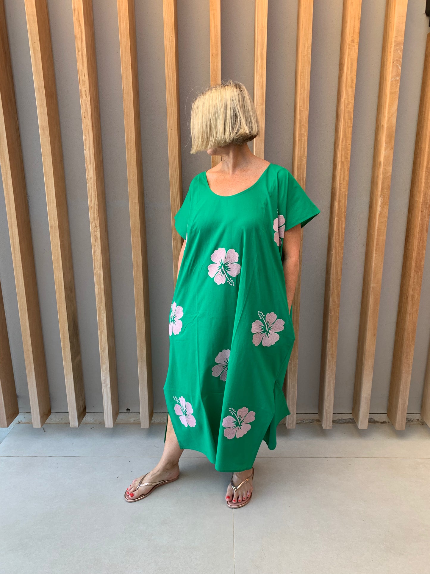 Green sleeveless dress with pink embroidered Hibiscus