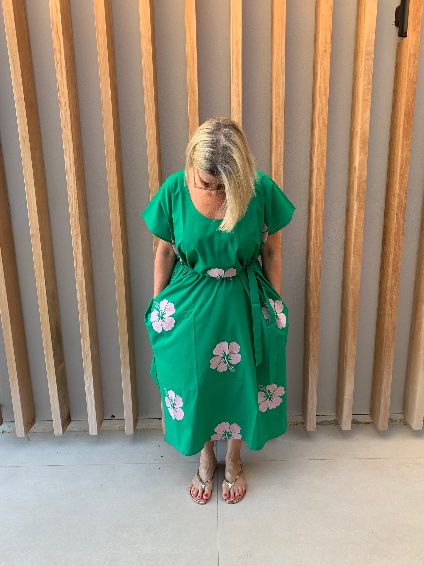 Green sleeveless dress with pink embroidered Hibiscus