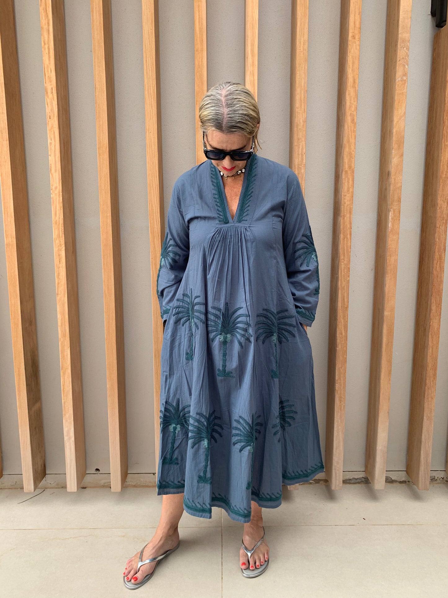 Grey dress with embroidered green palm pattern