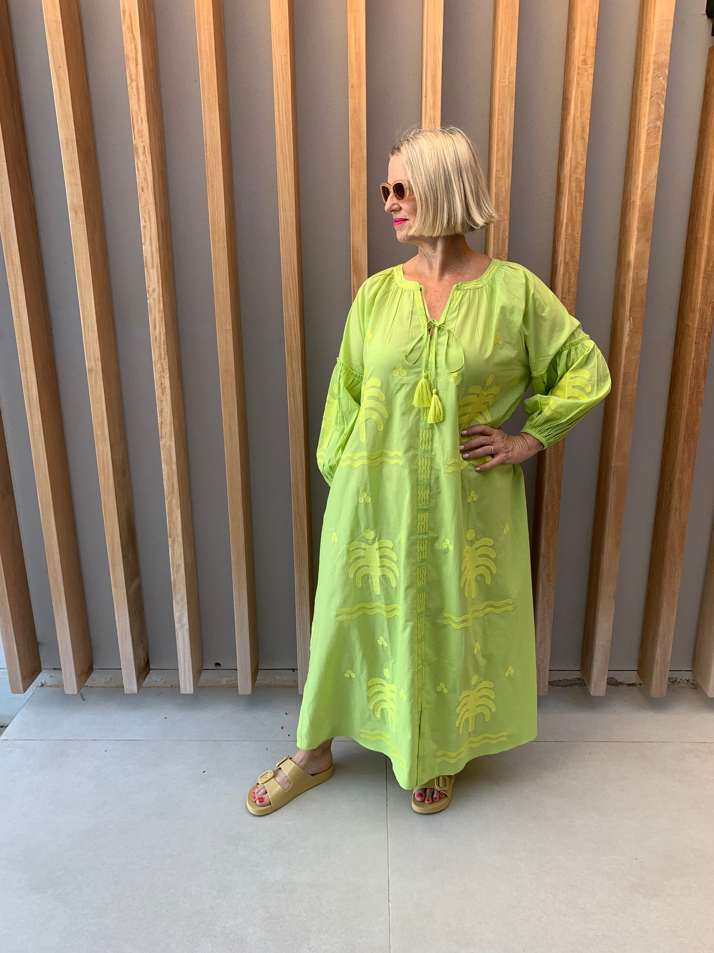 Lime green dress with embroidered palm pattern