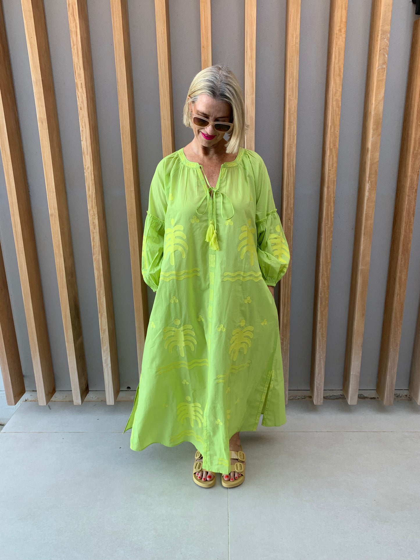 Lime green dress with embroidered palm pattern