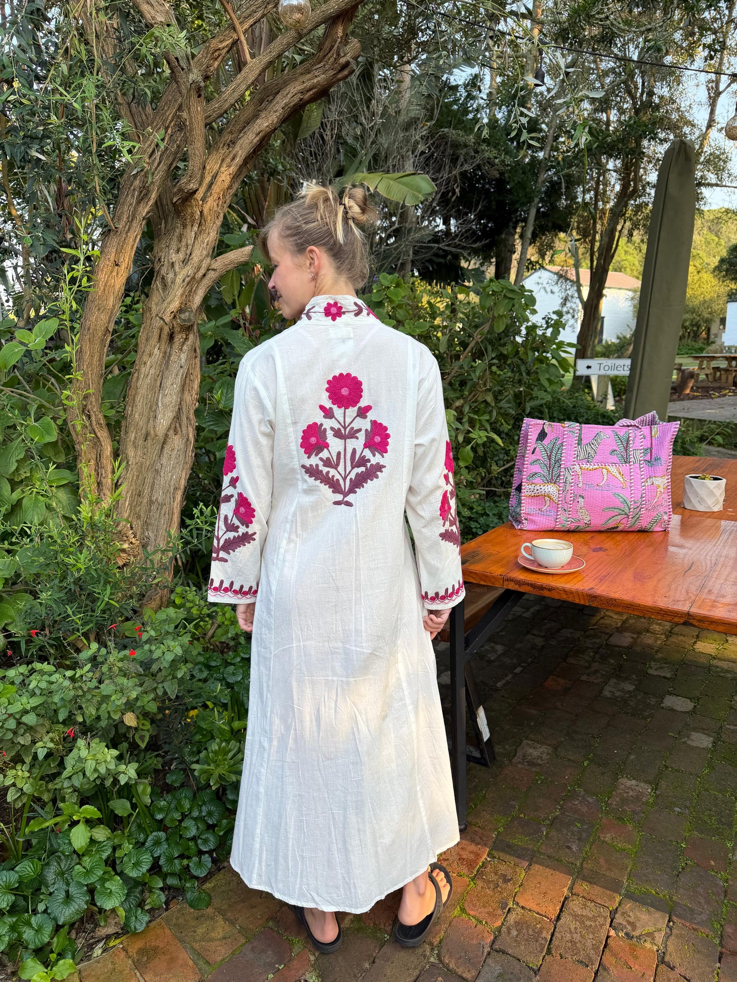 White dress with embroidered Magenta pink daises pattern