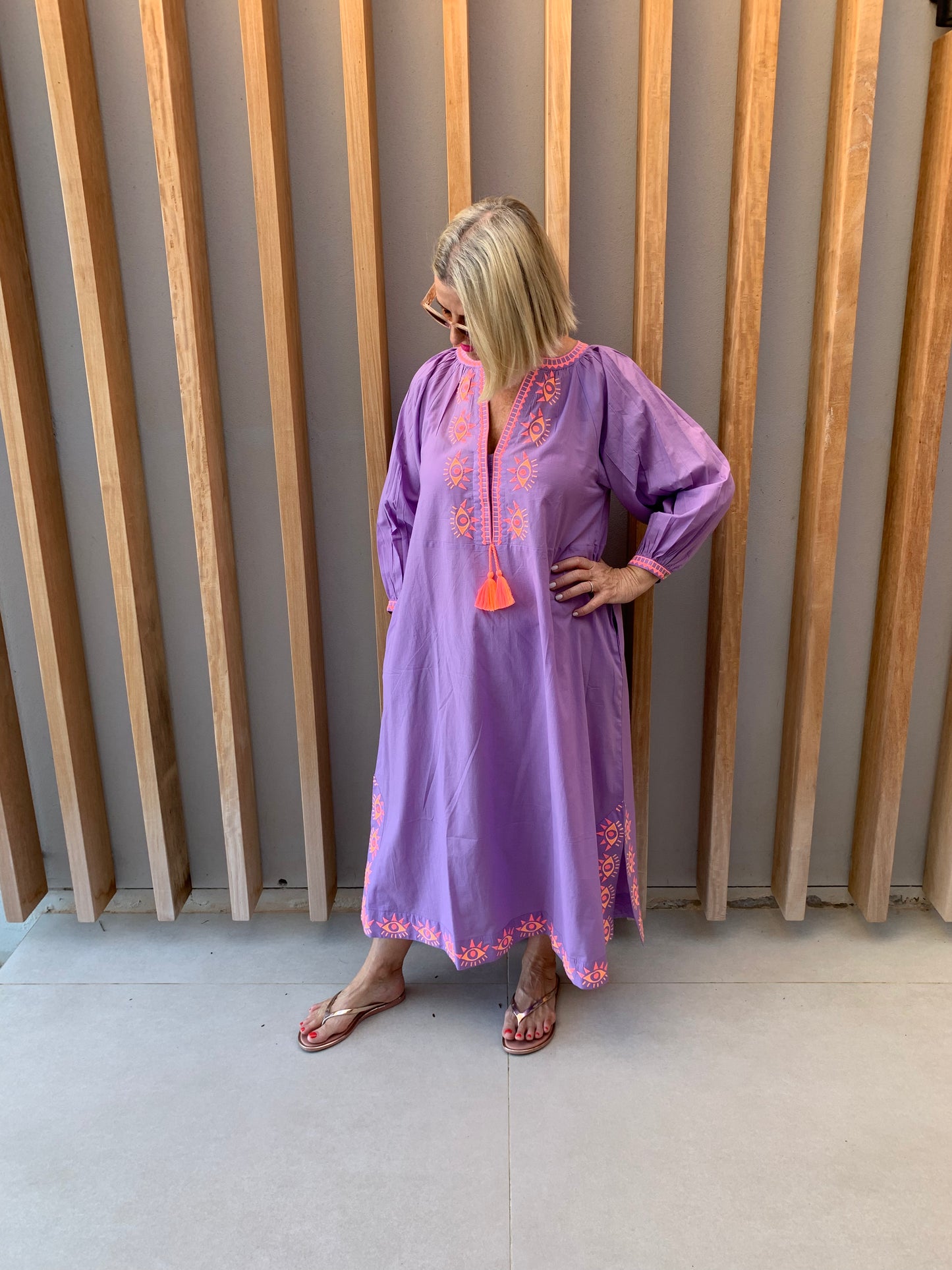 Mauve dress with embroidered orange geometric pattern