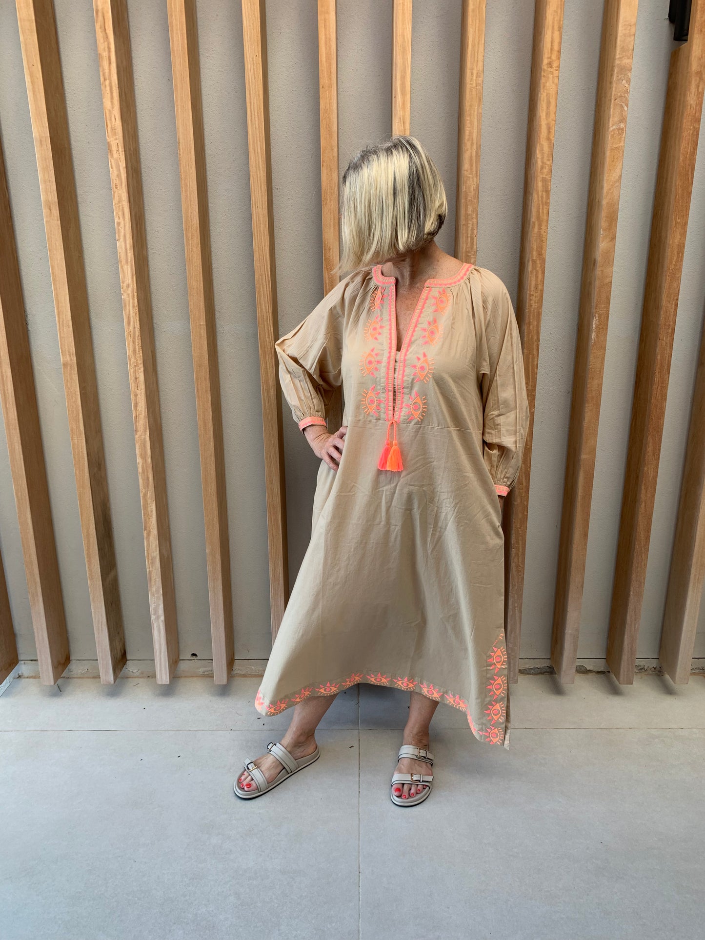 Nude colour dress with orange geometric pattern
