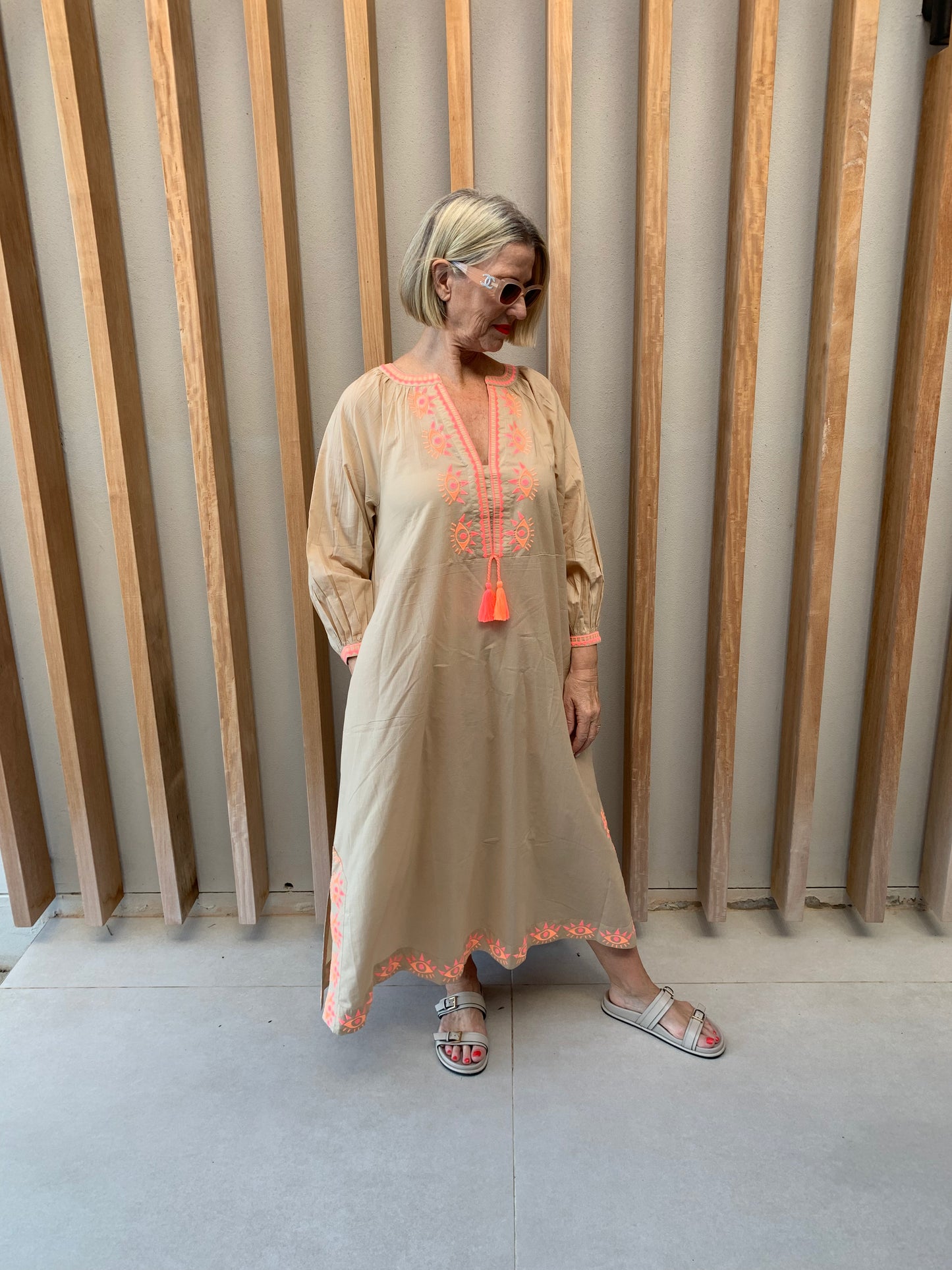 Nude colour dress with orange geometric pattern