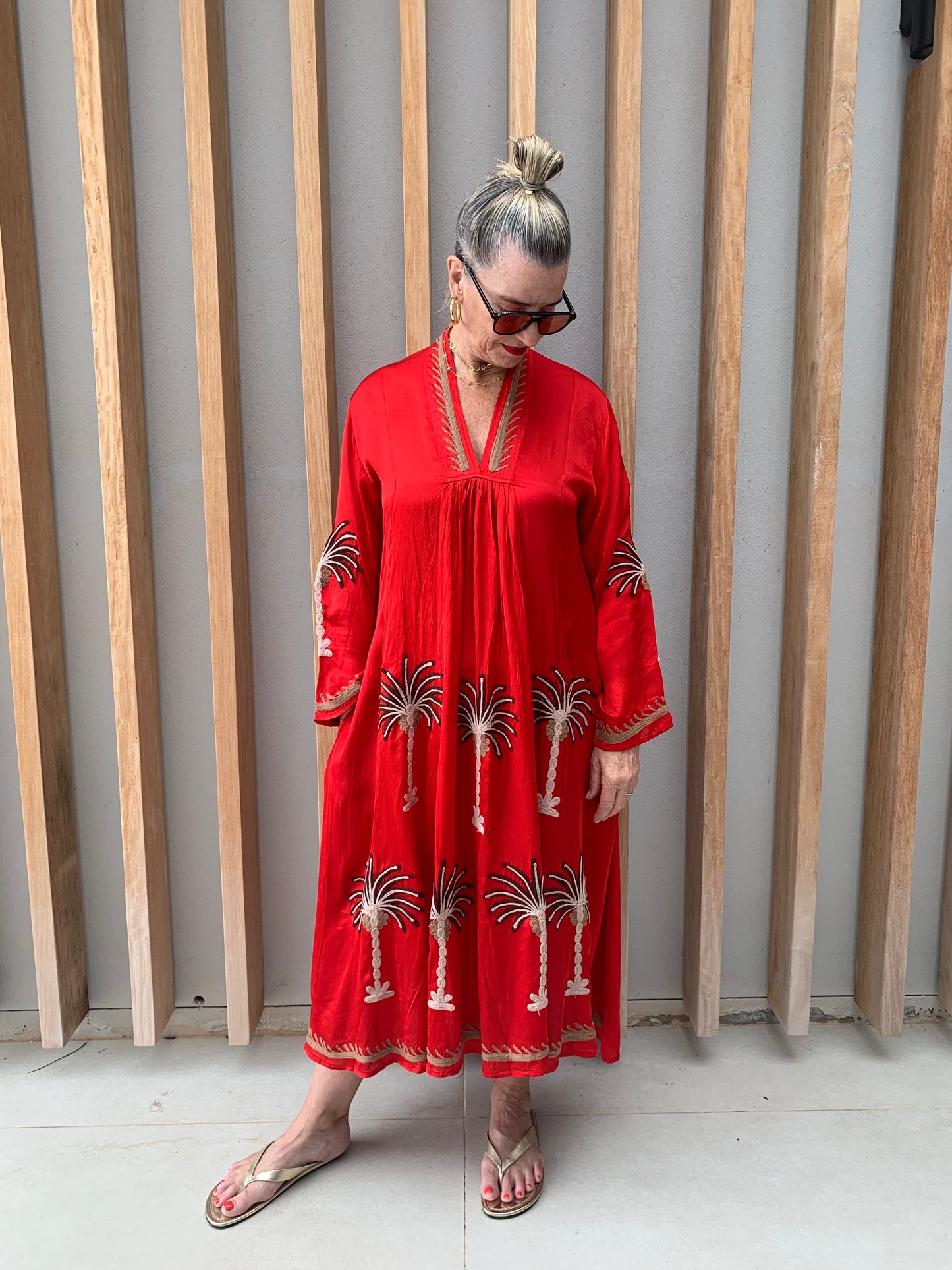 Red silk dress with floral palm pattern