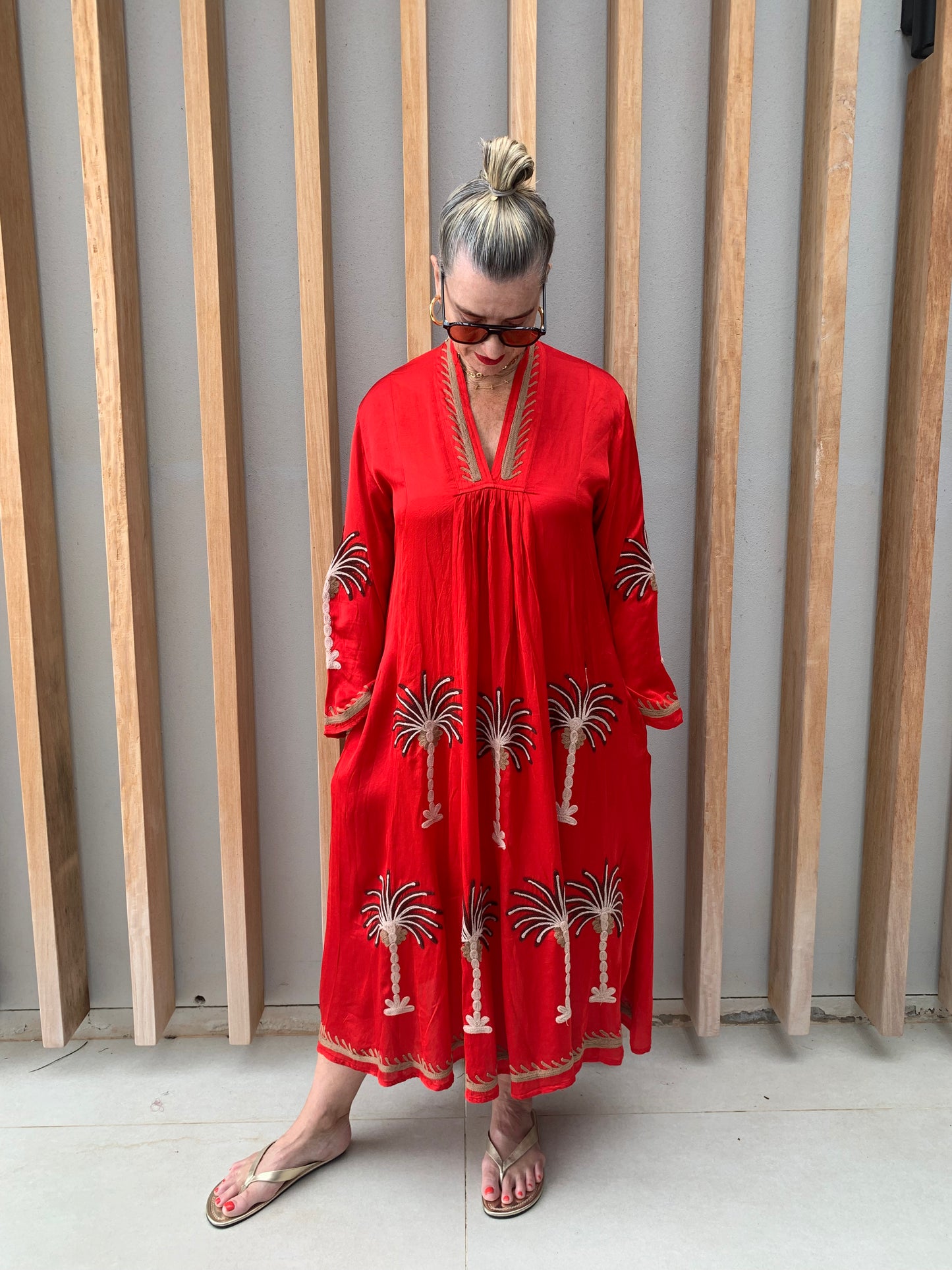 Red silk dress with floral palm pattern