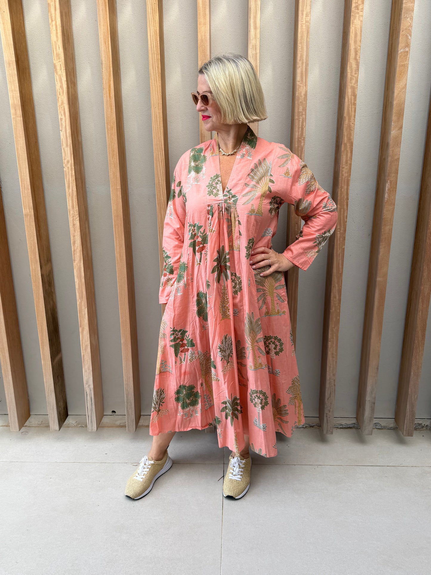 Salmon dress with floral palm pattern