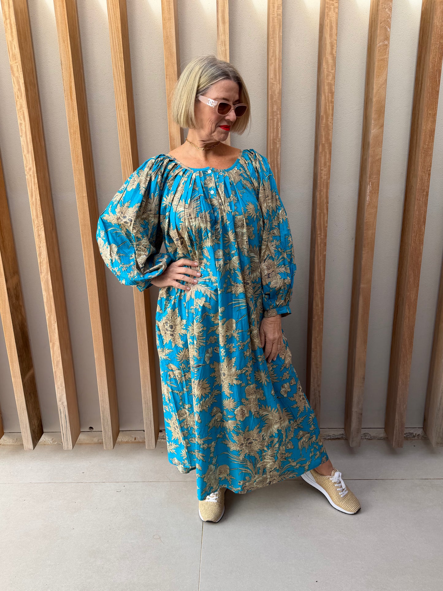 Turquoise dress with beige floral pattern