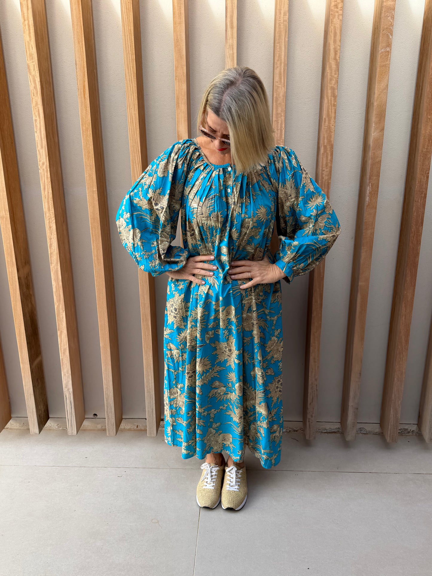 Turquoise dress with beige floral pattern
