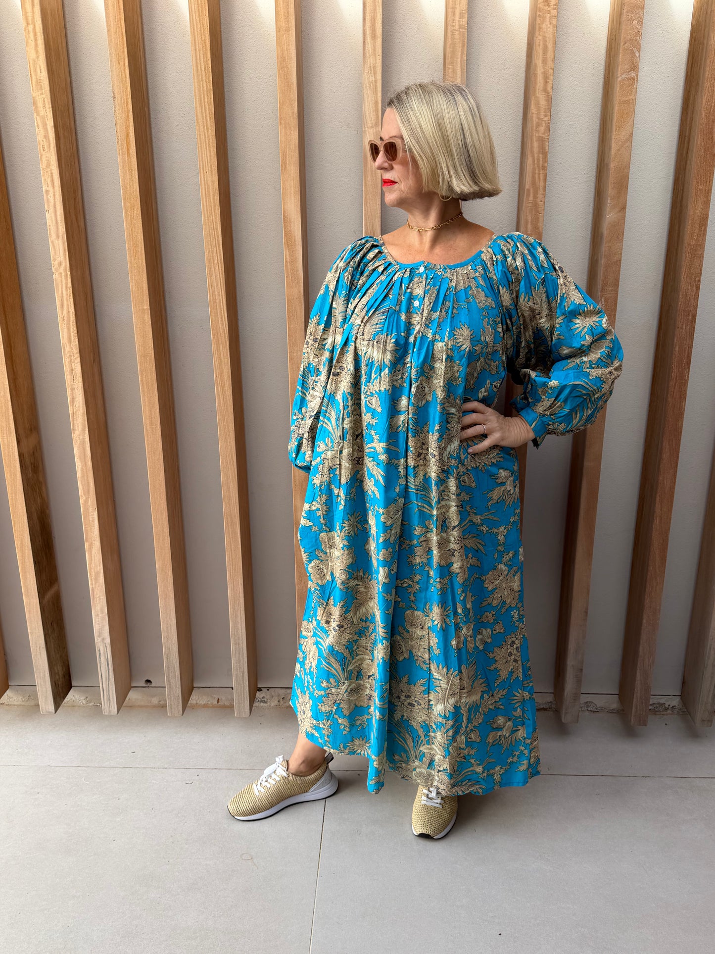 Turquoise dress with beige floral pattern