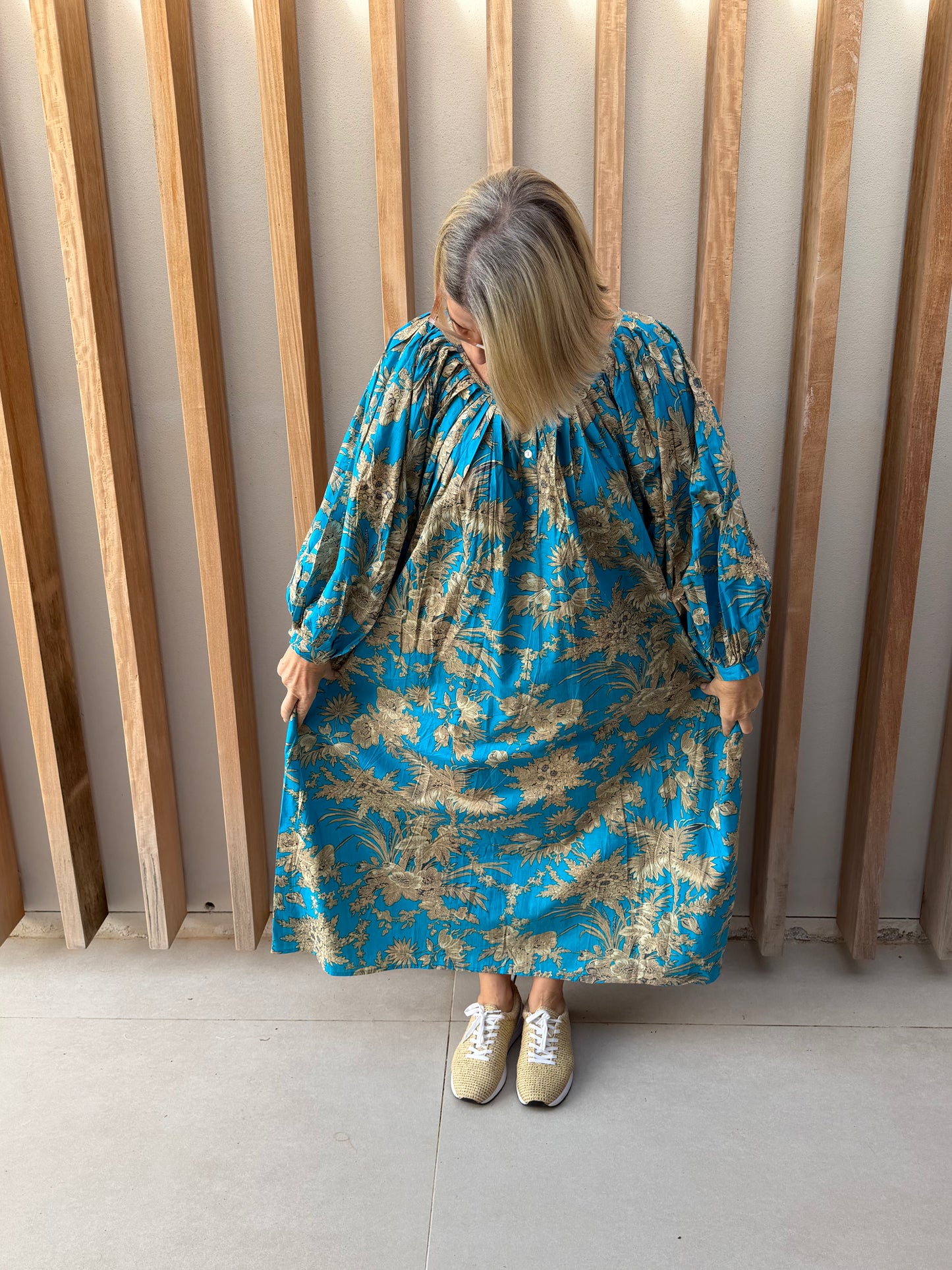 Turquoise dress with beige floral pattern