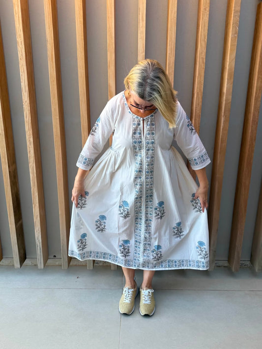 White dress with blue floral pattern