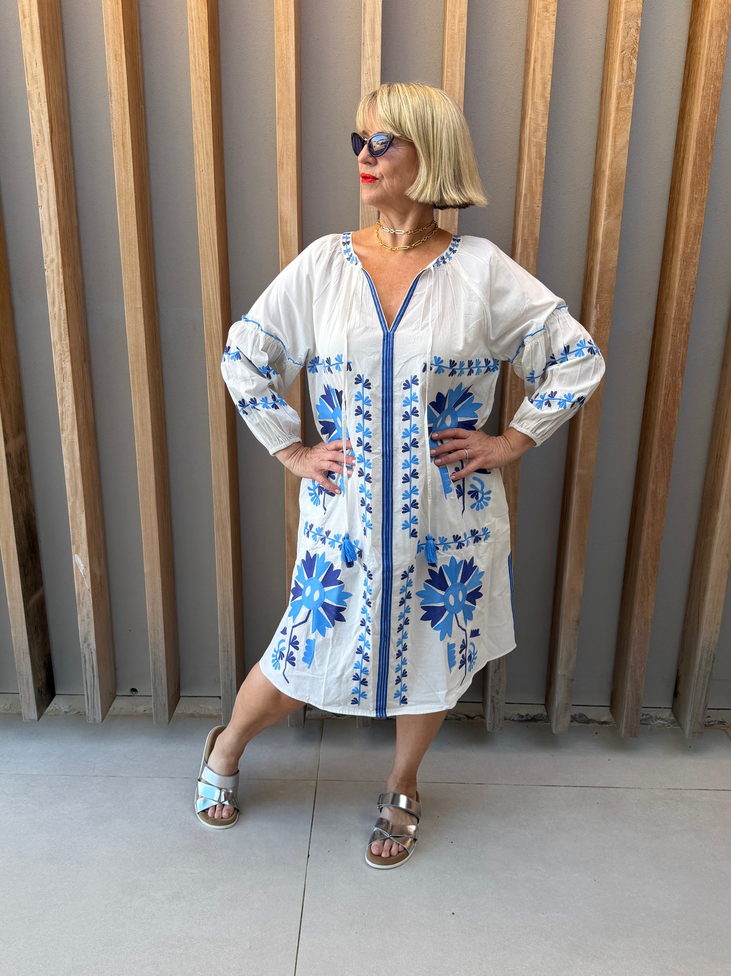 White dress with blue embroidered pattern