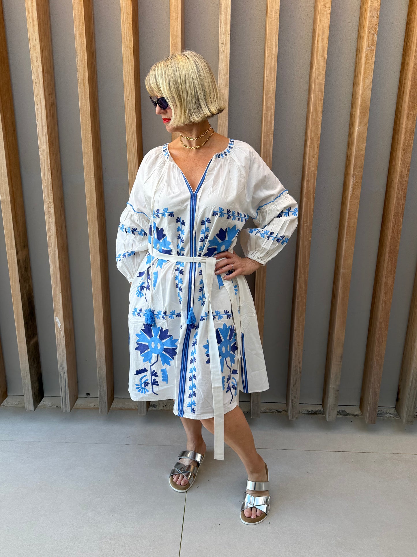 White dress with blue embroidered pattern