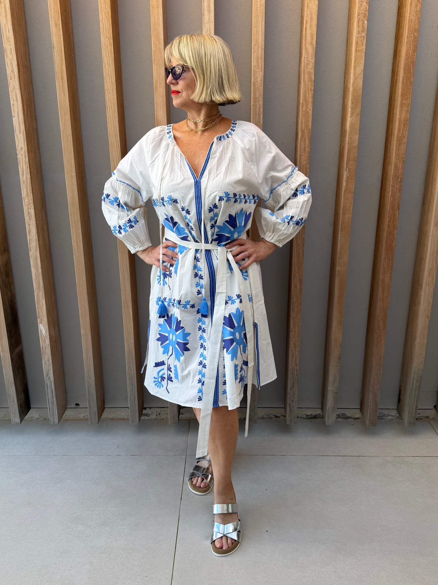 White dress with blue embroidered pattern