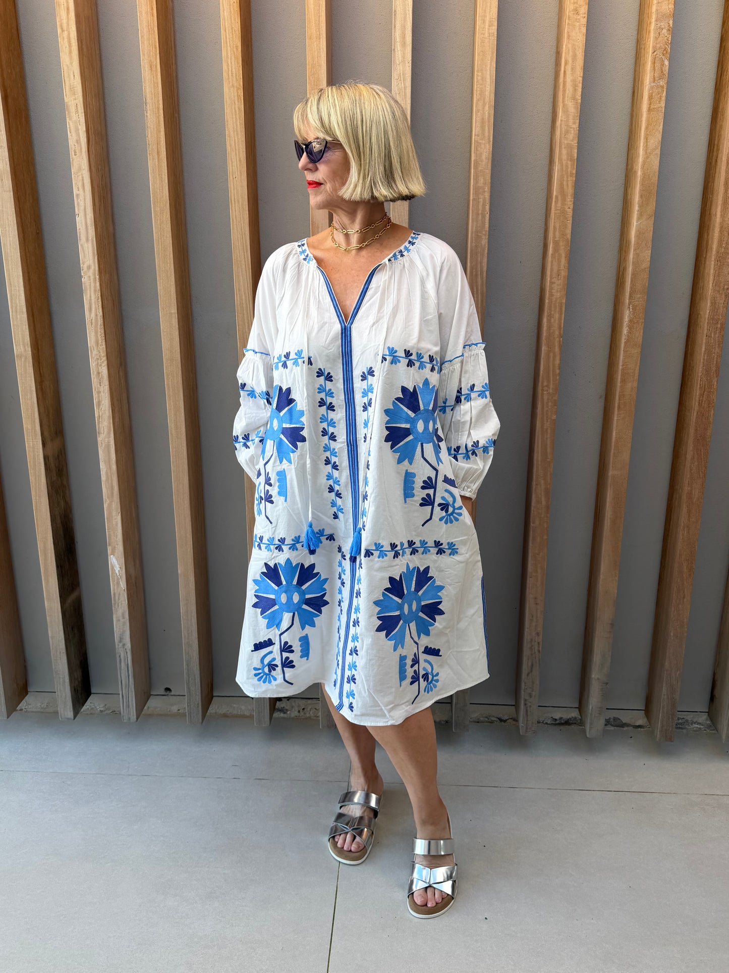 White dress with blue embroidered pattern