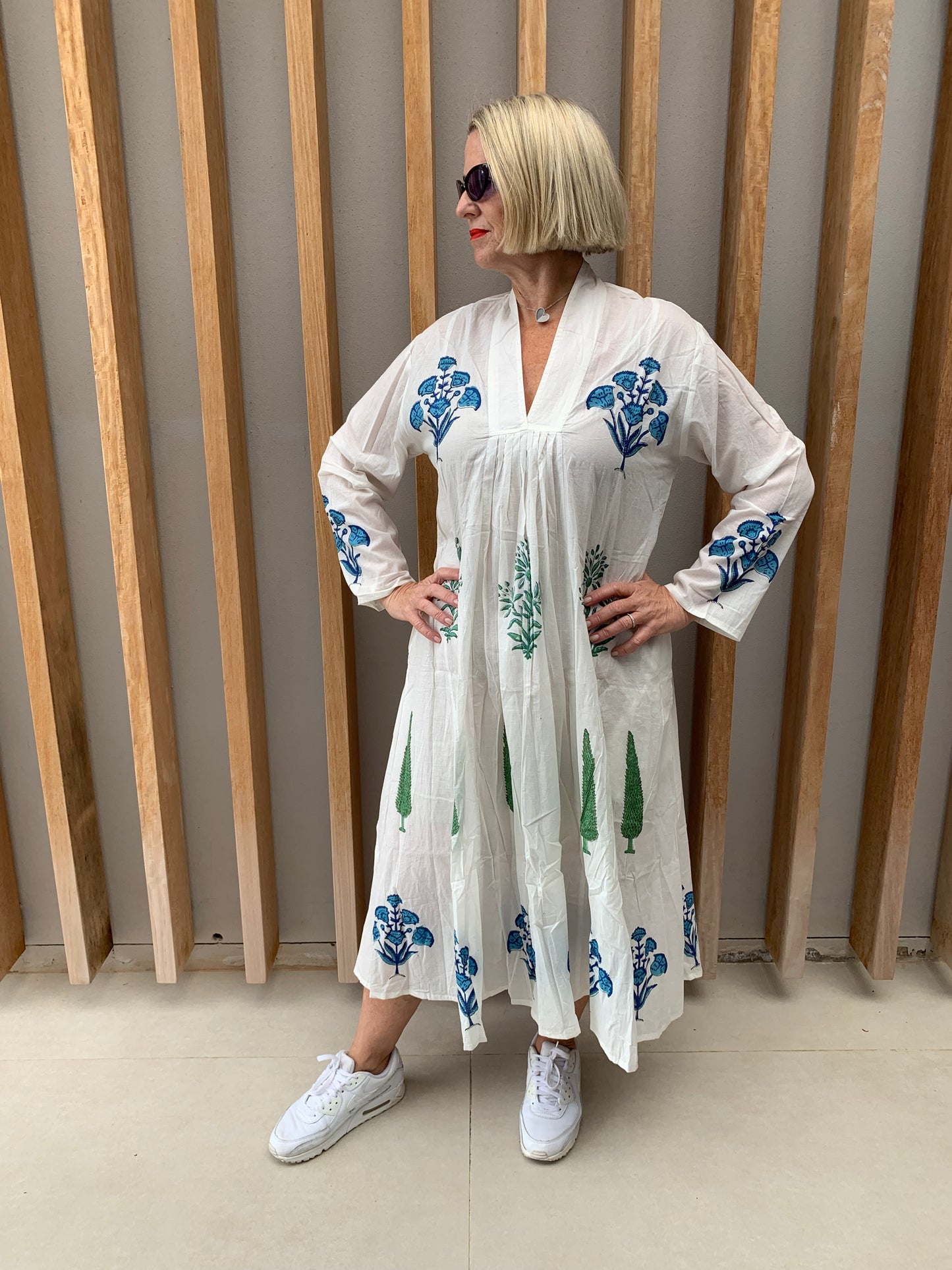 White dress with blue floral & green conifer pattern