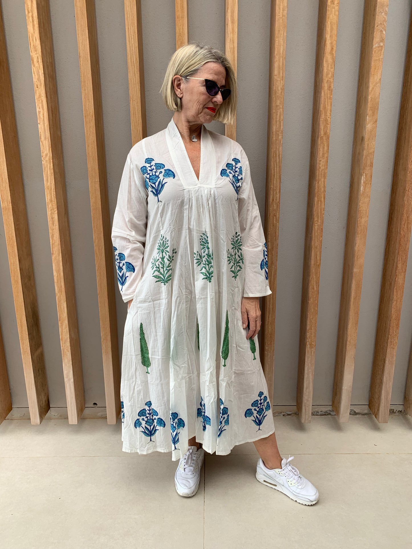 White dress with blue floral & green conifer pattern