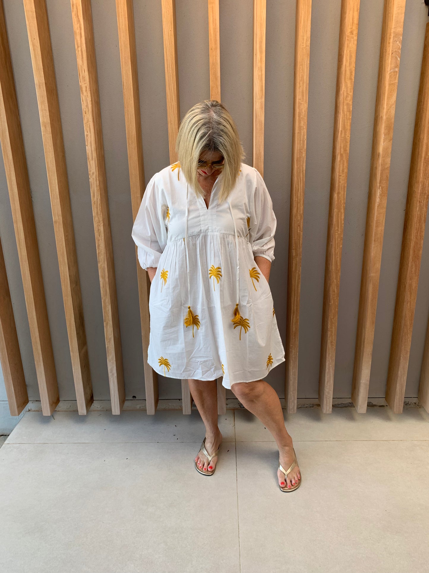 White dress with gold embroidered palm pattern