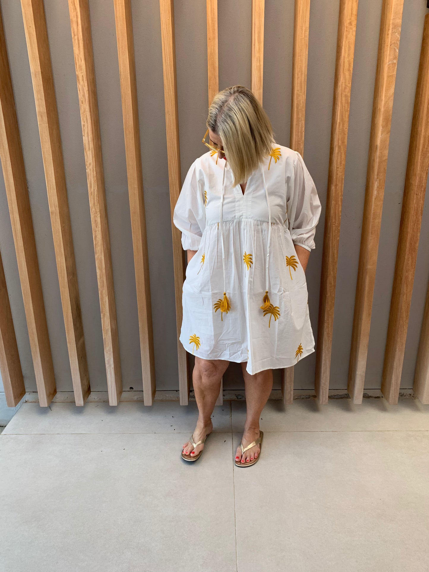 White dress with gold embroidered palm pattern
