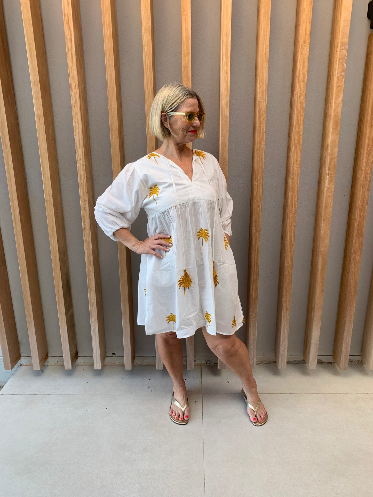 White dress with gold embroidered palm pattern