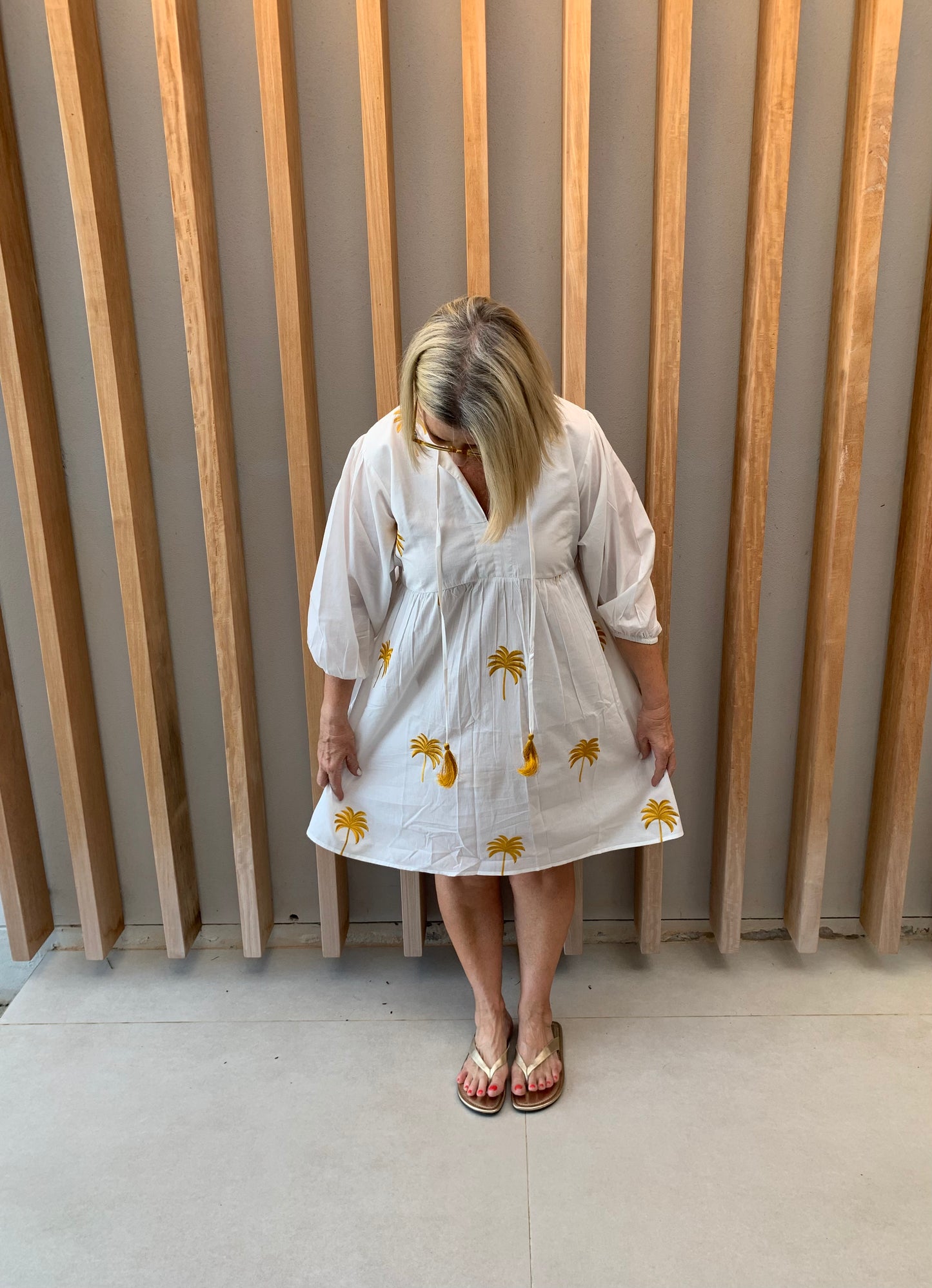 White dress with gold embroidered palm pattern