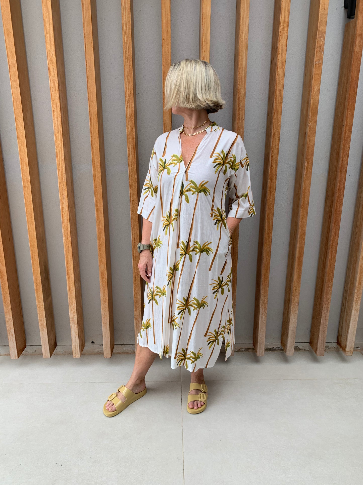 White dress with green palm floral pattern