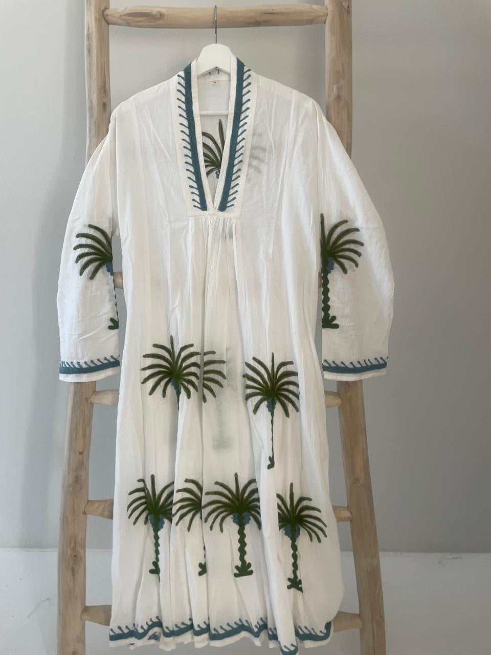 White dress with embroidered green floral palm