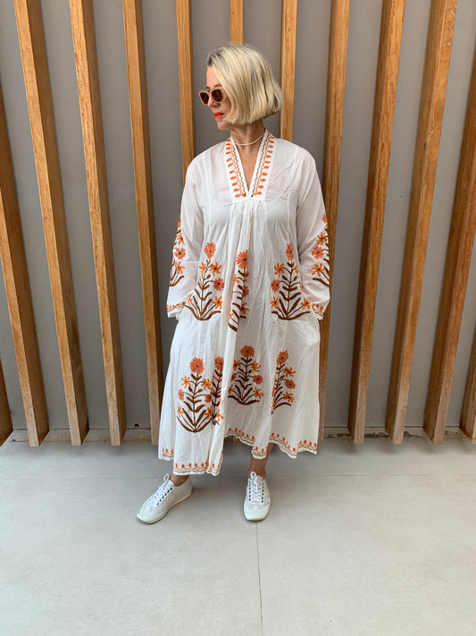 White dress with embroidered orange & brown daisy