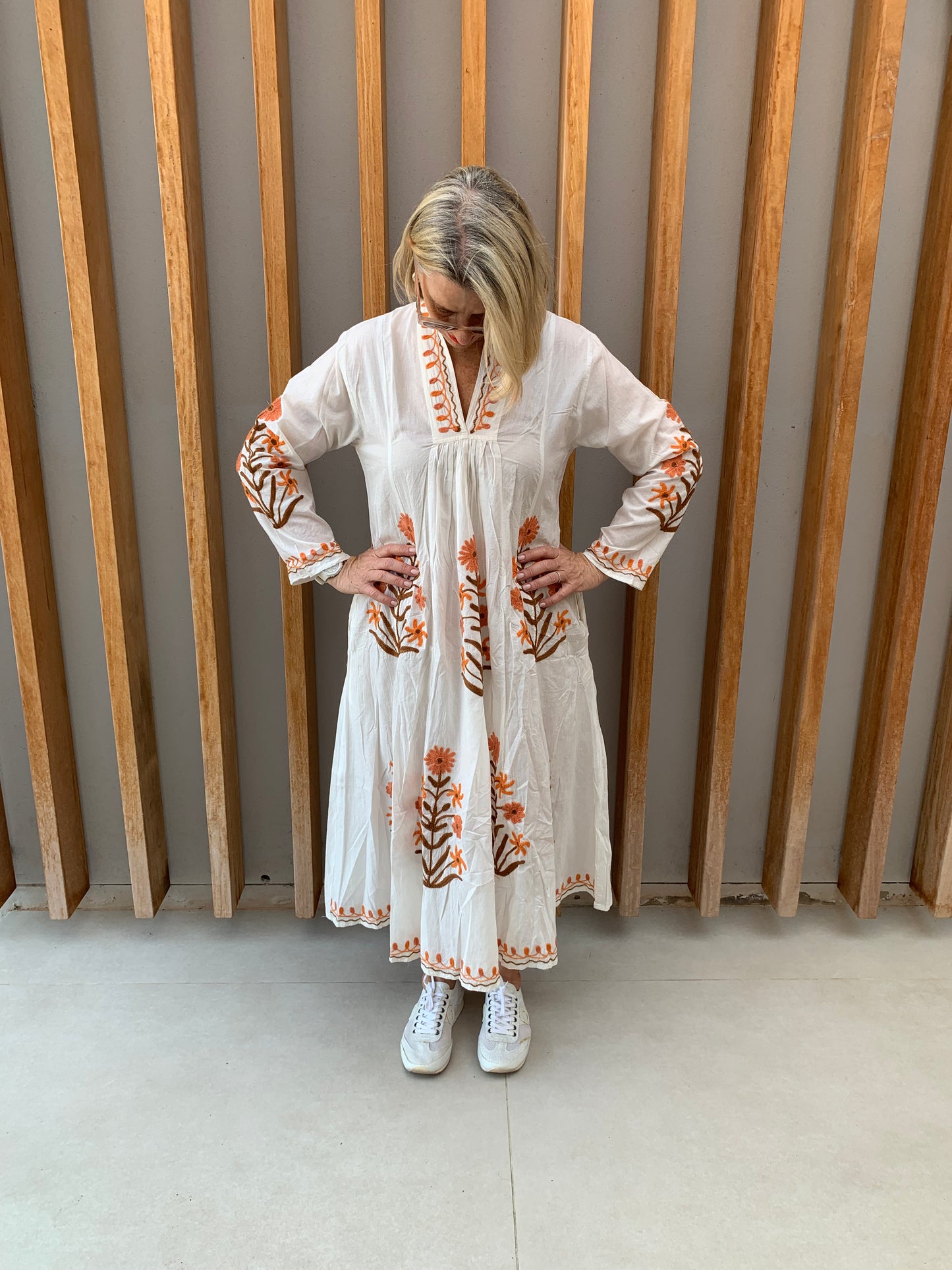 White dress with embroidered orange & brown daisy